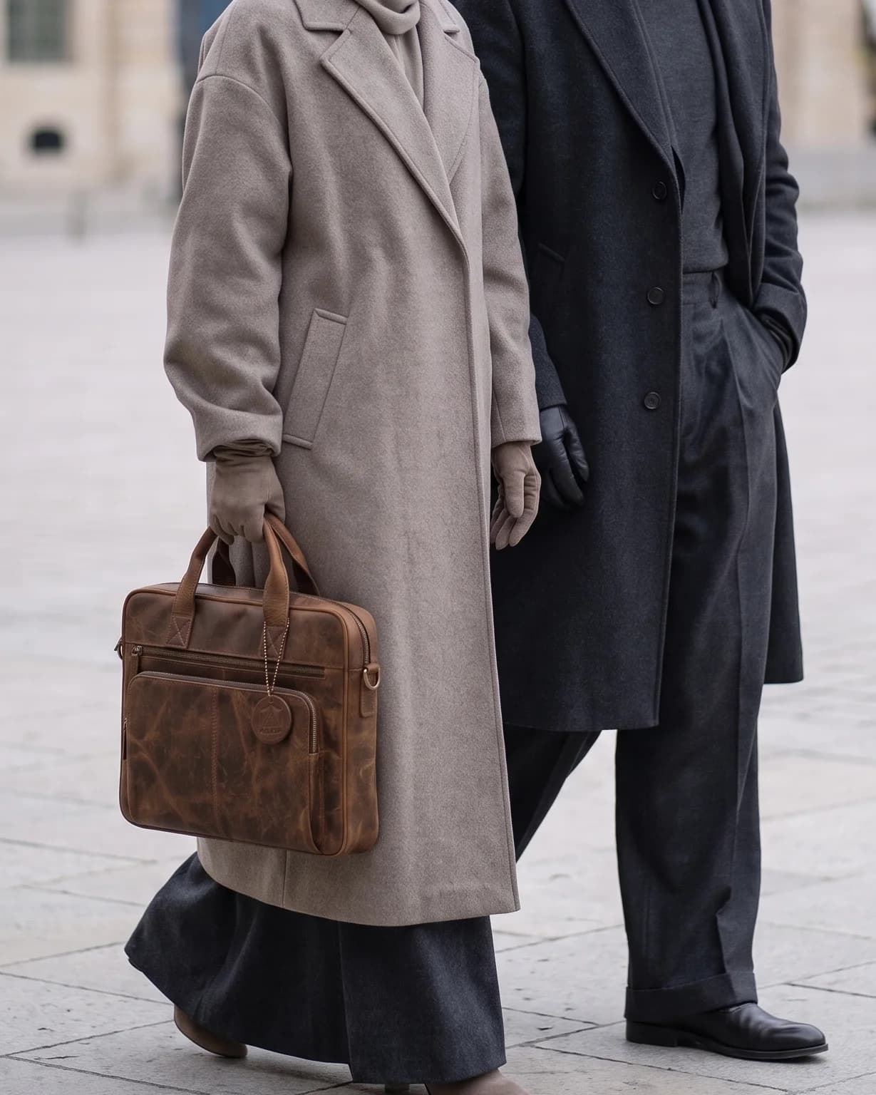 The distressed brown Art 301 leather laptop bag carried by its top handles